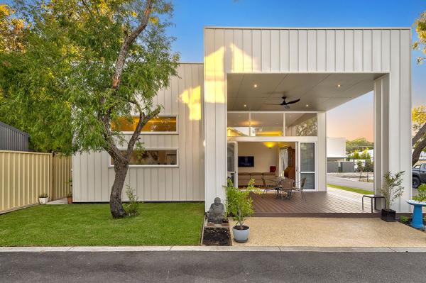 New affordable and low maintenance house with white standing seam cladding and timber floors