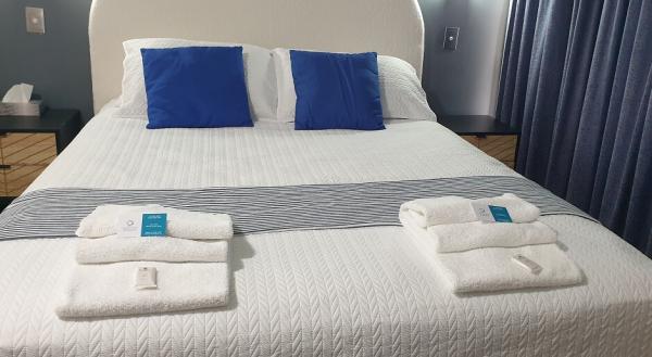 Freshly made queen bed and linen in our 1 bedroom motel rooms at Central Motel Ipswich