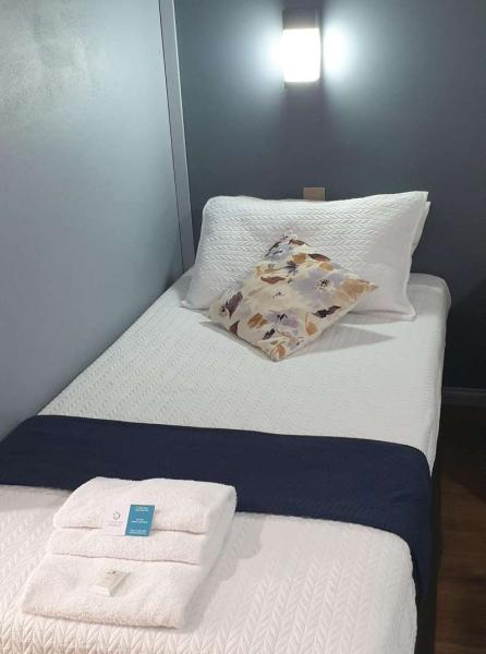 Freshly made single bed and linen at Central Motel Ipswich